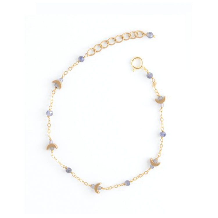 A delicate gold chain bracelet with small faceted lavender beads and crescent moon charms, displayed on a clean white background.